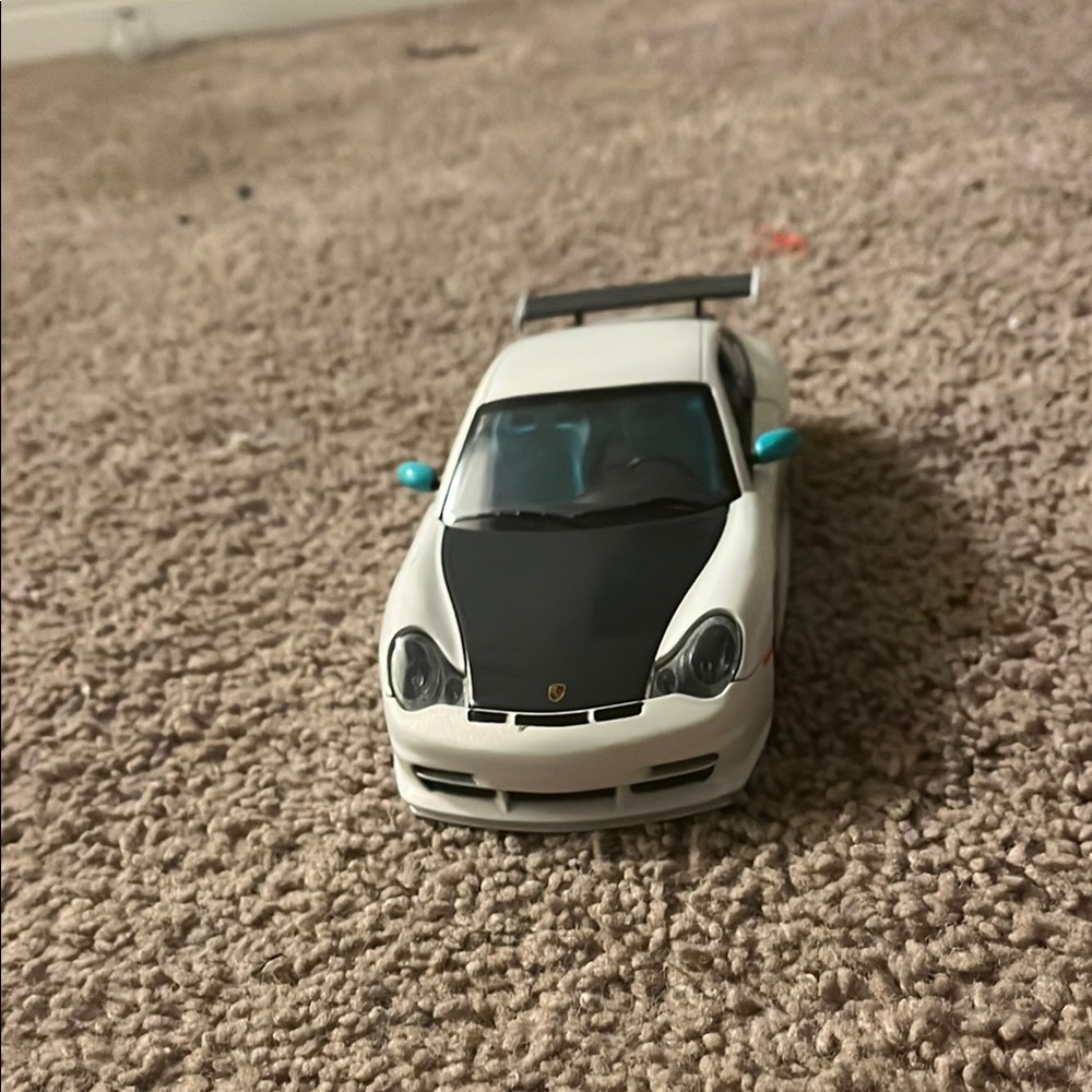 White and Black Toy Car with Blue Accents